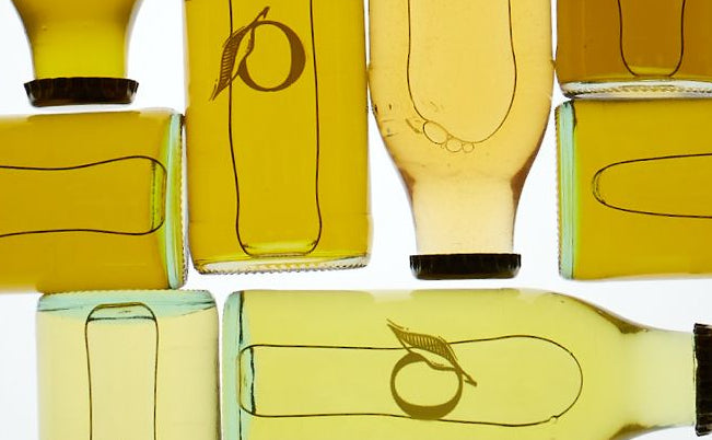 Collection of glass bottles with a logo of Olivella on white background